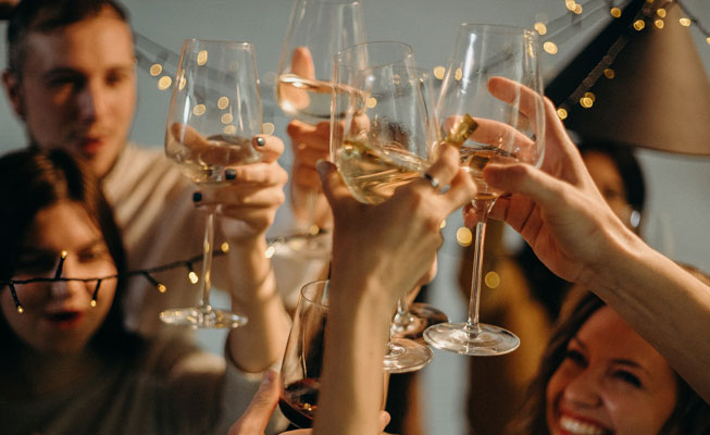 people raising their glasses in a toast